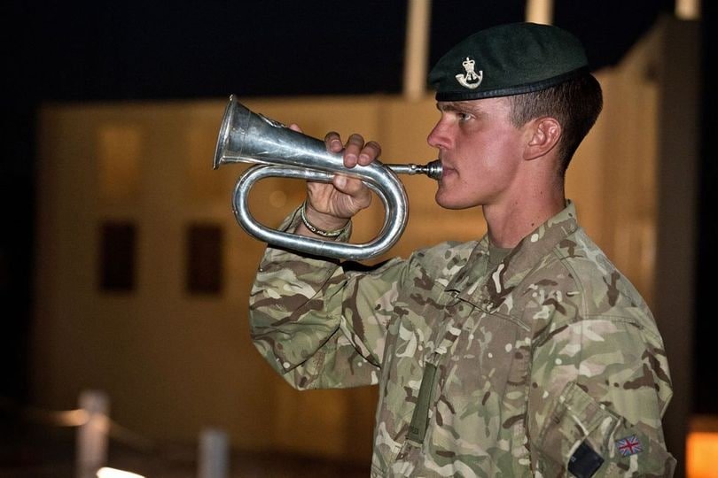 A soldier plays the Last Post at Camp Bastion